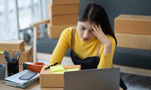 stressed woman using laptop computer and working problem to selling product online.